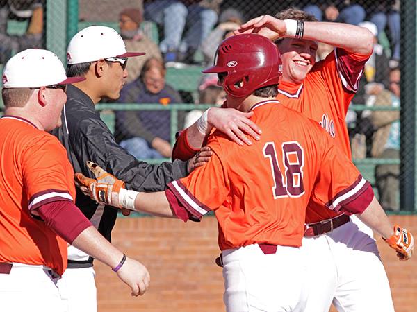 Infielder Greg Vourlomis receives praise from teammates and coaches after hitting a home run against Piedmont. Courtesy of Zach Selby.