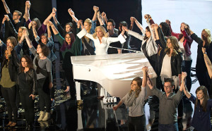 Lady Gaga holding hands in solidarity with survivors of sexual assault at her performance at the Oscars. Photo from Entertainment Weekly.