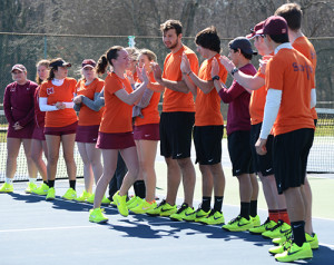 The MC men’s and women’s tennis teams perform their traditional pre-game line up. Both teams start off their matches by calling out the top six players and shaking hands with their opponent. Photo from MC Communications.