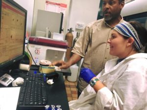 Morgan Gast receives some assistance from Dr. Valance Washington in his lab at the University of Puerto Rico. Photo courtesy of MC communications.