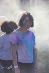 Julia Birch gets covered in the Holi powder.