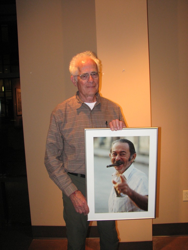 Young holds his picture, “Mario from Cuba”, a photograph with special meaning for the artist. Photo Courtesy of Alexandria Rodriguez