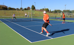 No. 2 doubles Boomer Russel (left) and Gabriel Rodriguez (right) align for a doubles play against Johnson University. Photo courtesy of Ariana Hansen.