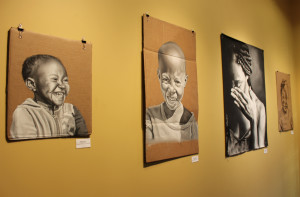 These paintings of South African children portray the "happy and bright aspect" of South Africa, Nzuza explained. Photo by Candace Whitman.