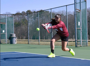 No. 5 Polyxeni Pavlides stretches out for a cross-court backhand. Photo by Savannah Bain.