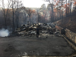 Kelby Fruecht stands amongst the ruins of his family’s Gatlinburg home following wildfires on Monday Nov. 29. Photo courtesy of Kelby Fruecht