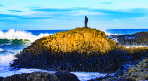 Sydney Perry stands atop of basalt rocks at Giants Causeway Ireland. Photo by Dalton Beard.