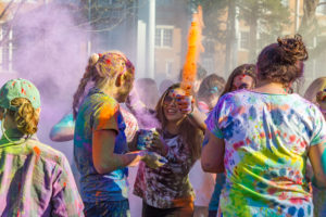 Students participating in GCO’s Holi Festival decorate their shirts and faces with powdered chalk. Photo by Beau Branton.